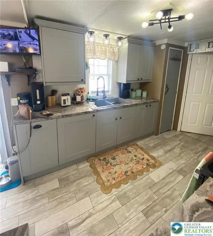 a kitchen with a sink cabinets and window