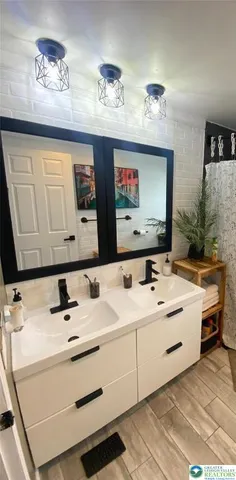 a bathroom with a sink vanity and mirror