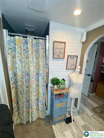 a view of a entryway with furniture and wooden floor