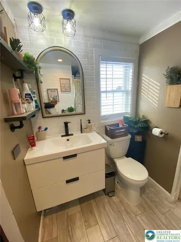 a bathroom with a toilet sink and mirror
