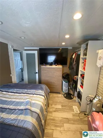 a bedroom with a bed and a large mirror