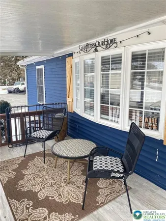 a balcony with table and chairs