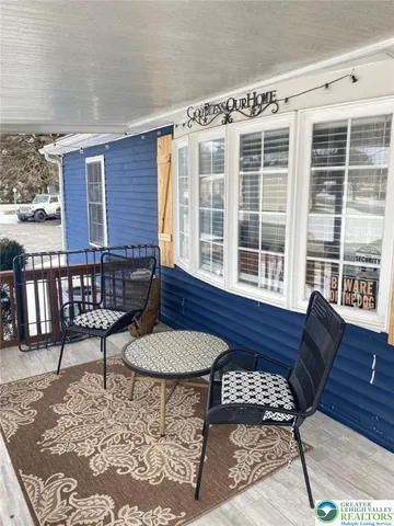 a balcony with table and chairs