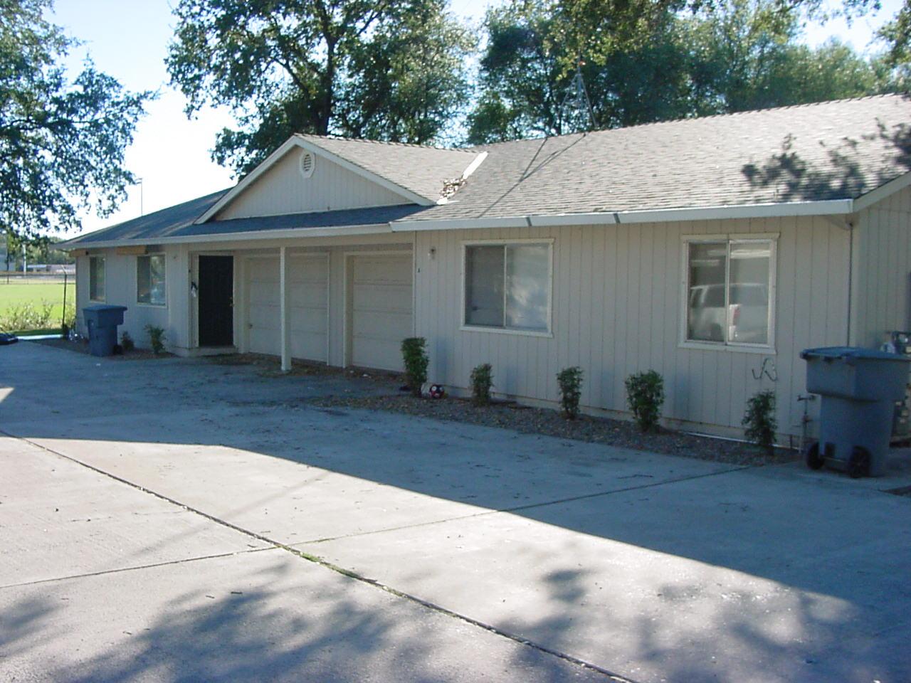 3236 Lawrence Road Redding, CA 96002 - Photo 1 of 1 a front view of a house with a yard and potted plants
