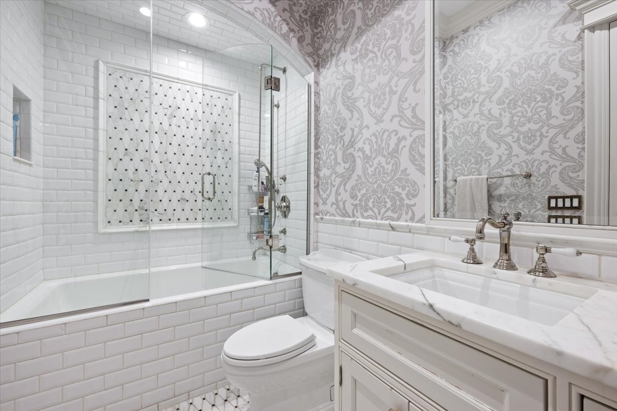 319 Sheridan Road Winnetka, IL 60093 - Photo 42 of 81 a bathroom with a sink toilet a mirror and shower
