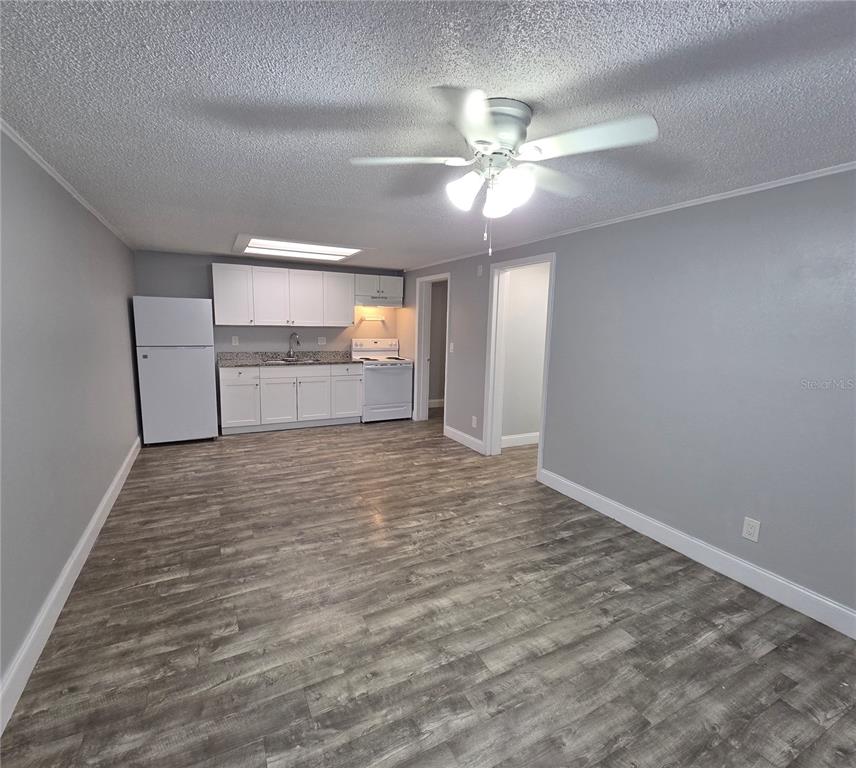 1400 Strawberry Place, Unit 6 Plant City, FL 33563 - Photo 2 of 11 a view of empty room with wooden floor and ceiling fan