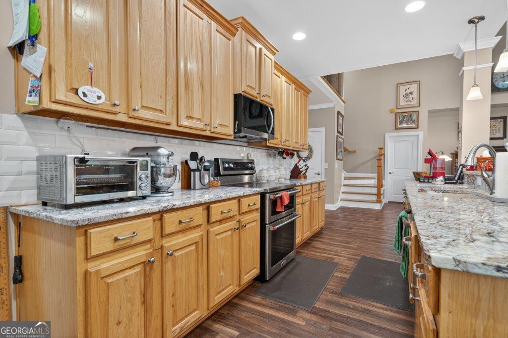 281 Jule Ingram Road Milledgeville, GA 31061 - Photo 11 of 79 a kitchen with stainless steel appliances granite countertop a stove a sink and a microwave