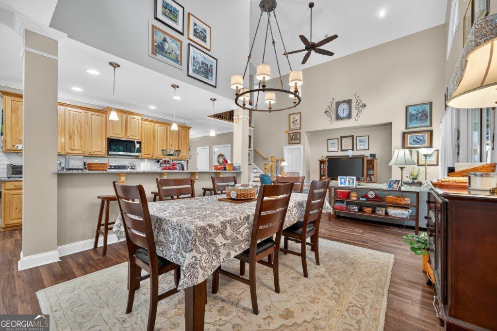 281 Jule Ingram Road Milledgeville, GA 31061 - Photo 15 of 79 a view of a dining room and livingroom with furniture wooden floor a chandelier