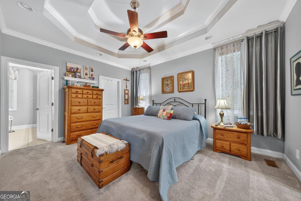 281 Jule Ingram Road Milledgeville, GA 31061 - Photo 19 of 79 a bedroom with a bed and a chandelier