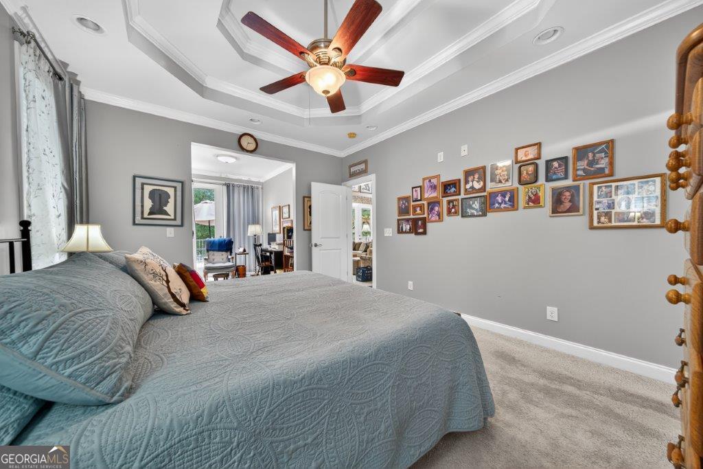 281 Jule Ingram Road Milledgeville, GA 31061 - Photo 20 of 79 a bedroom with a large bed and a chandelier