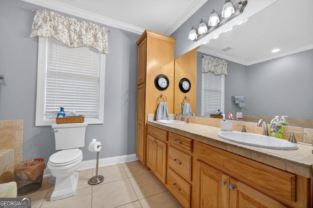 281 Jule Ingram Road Milledgeville, GA 31061 - Photo 24 of 79 a bathroom with a toilet sink double vanity and mirror