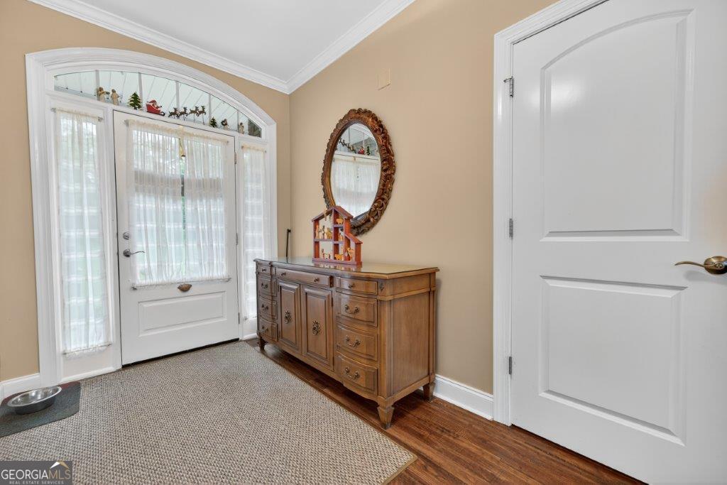 281 Jule Ingram Road Milledgeville, GA 31061 - Photo 3 of 79 a view of a hallway with entryway wooden floor and front door