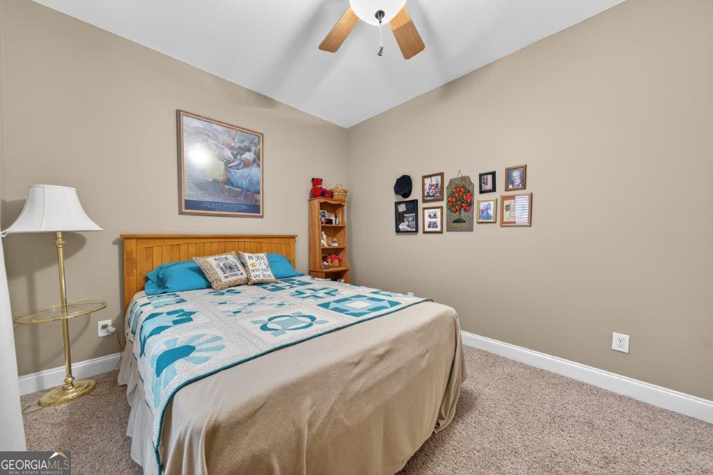 281 Jule Ingram Road Milledgeville, GA 31061 - Photo 34 of 79 a bedroom with a bed and a painting on the wall