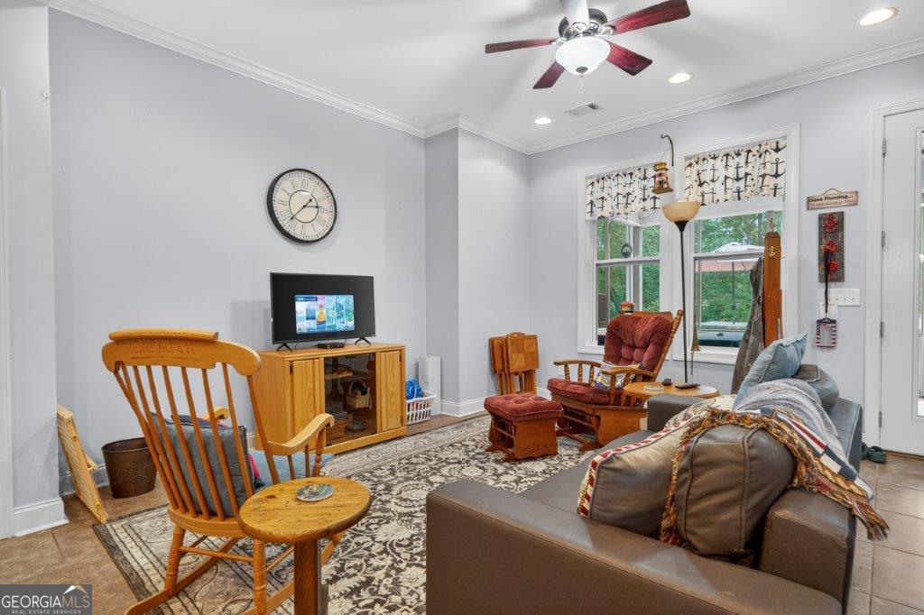 281 Jule Ingram Road Milledgeville, GA 31061 - Photo 39 of 79 a living room with furniture a fireplace and a window