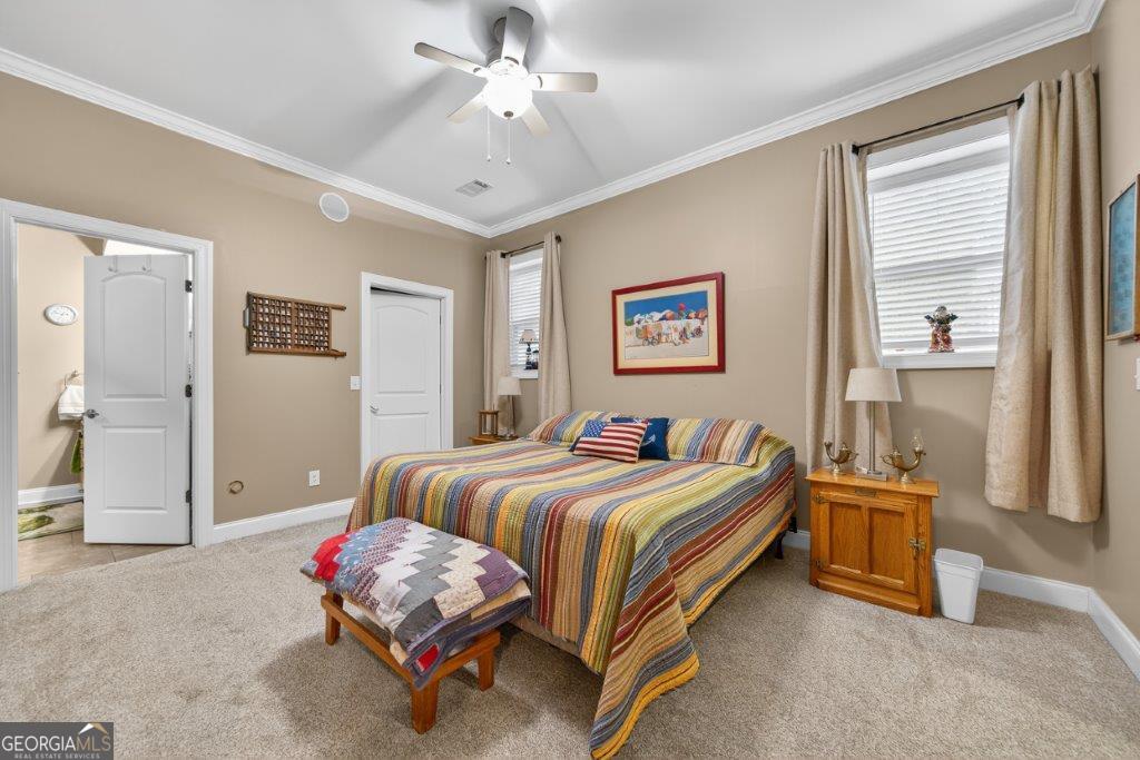 281 Jule Ingram Road Milledgeville, GA 31061 - Photo 47 of 79 a bedroom with a bed and a chandelier