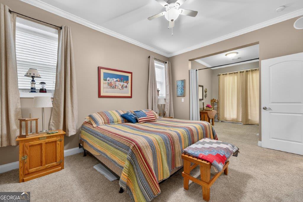 281 Jule Ingram Road Milledgeville, GA 31061 - Photo 48 of 79 a spacious bedroom with a bed and a chandelier