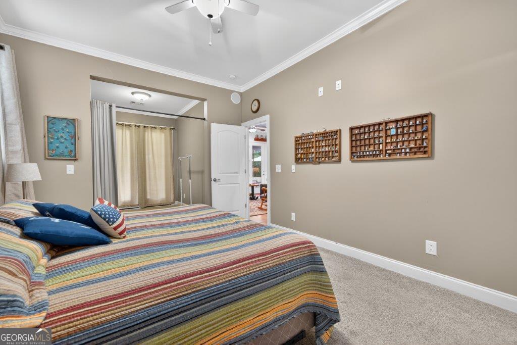 281 Jule Ingram Road Milledgeville, GA 31061 - Photo 49 of 79 a bedroom with a bed and a large mirror