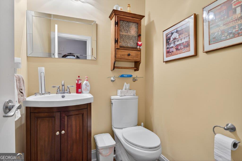 281 Jule Ingram Road Milledgeville, GA 31061 - Photo 53 of 79 a bathroom with a toilet a sink and mirror