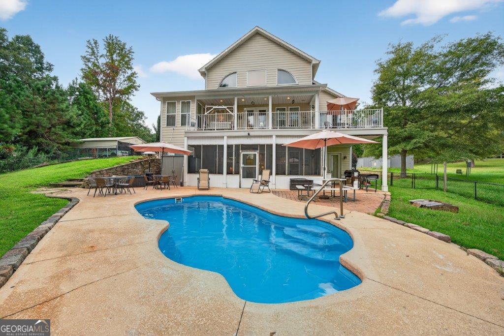281 Jule Ingram Road Milledgeville, GA 31061 - Photo 63 of 79 a swimming pool with outdoor seating and yard