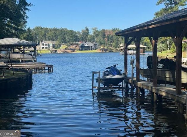281 Jule Ingram Road Milledgeville, GA 31061 - Photo 78 of 79 a view of a patio with table and chairs under an umbrella
