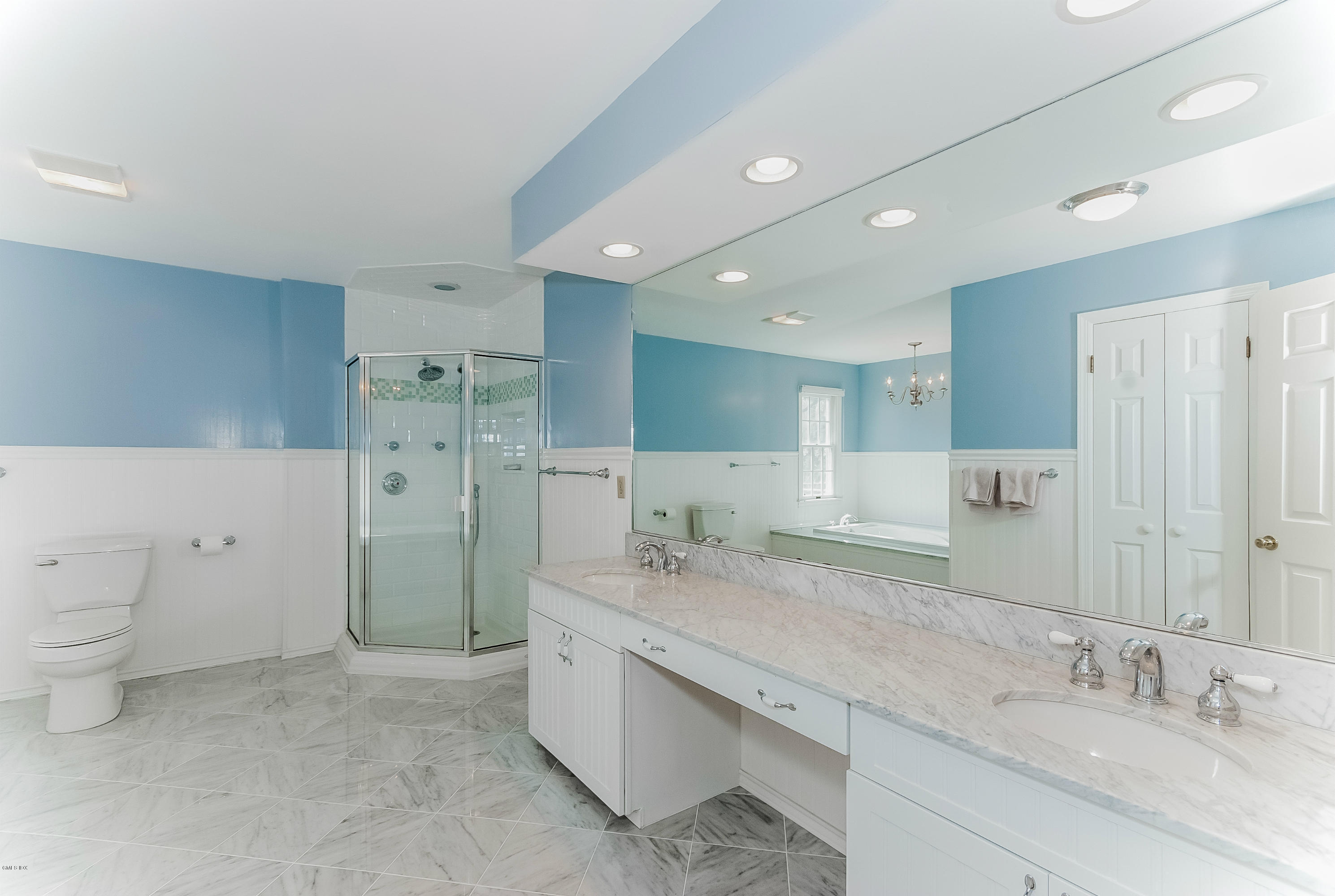 21 Roberta Lane Greenwich, CT 06830 - Photo 20 of 39 a bathroom with a granite countertop double vanity sink a mirror and a toilet