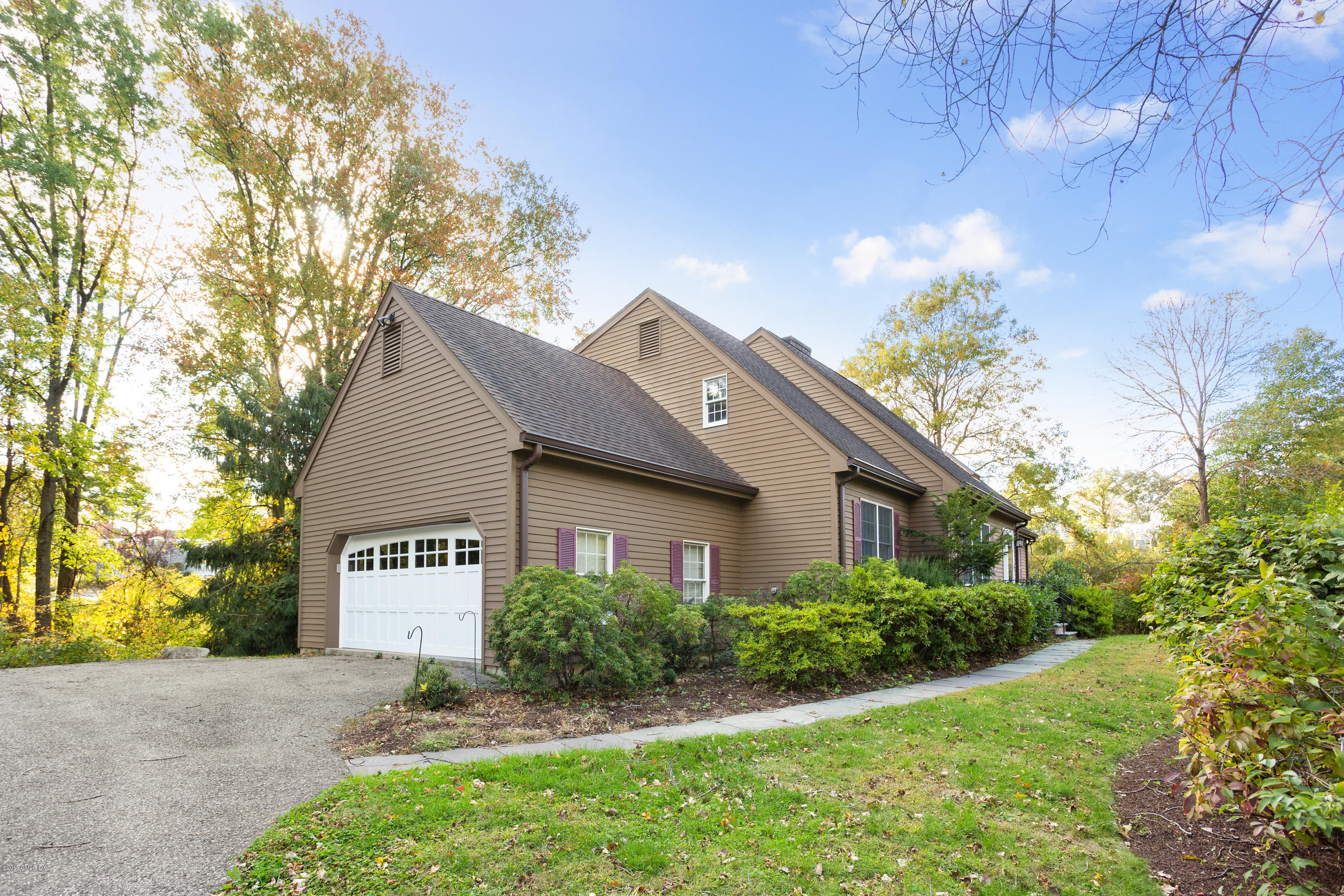 21 Roberta Lane Greenwich, CT 06830 - Photo 2 of 39 a sign board with flower plants and wooden fence