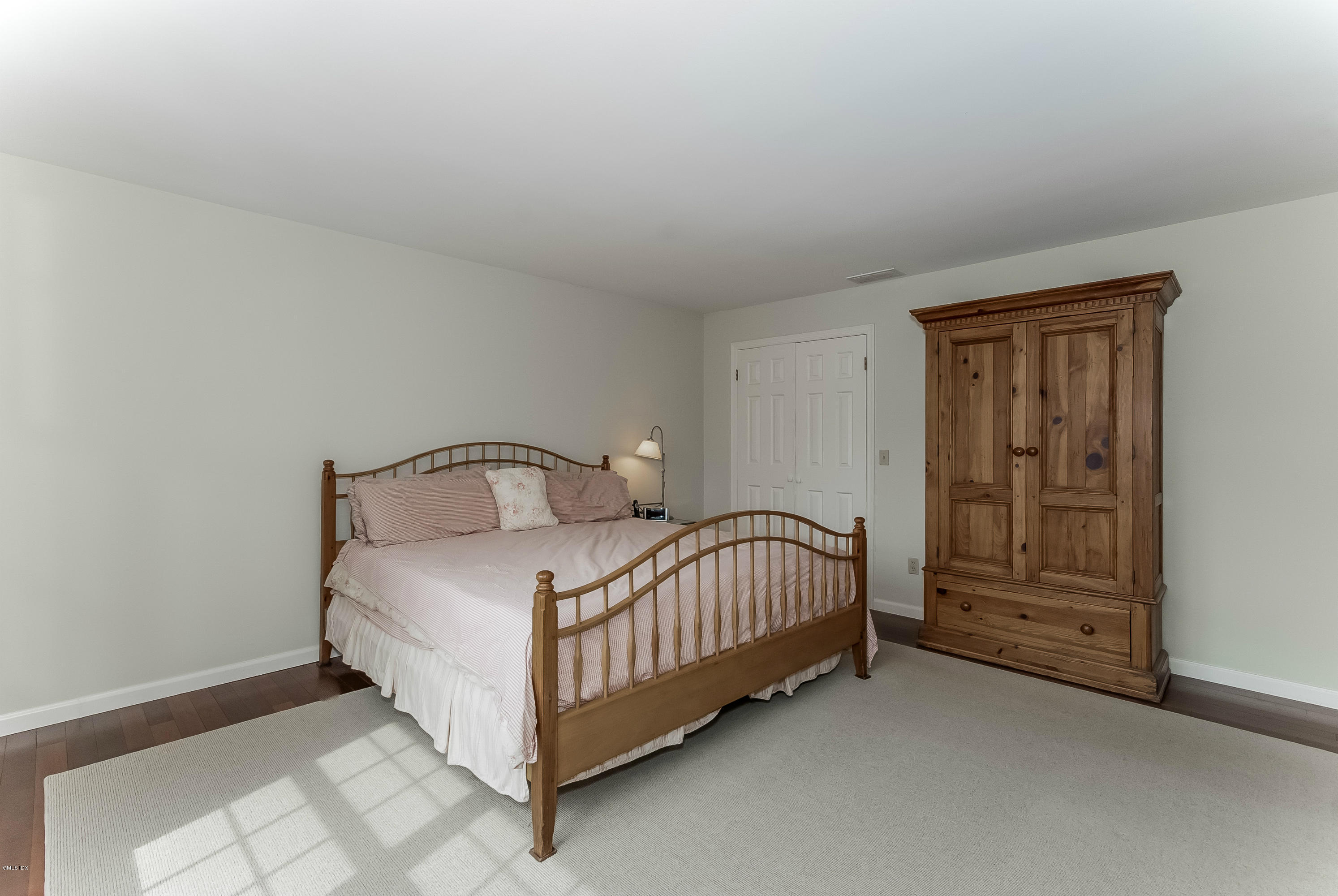 21 Roberta Lane Greenwich, CT 06830 - Photo 23 of 39 a bedroom with a bed and dresser