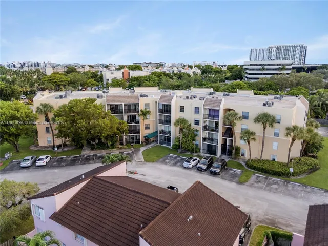 an aerial view of multiple houses with a yard