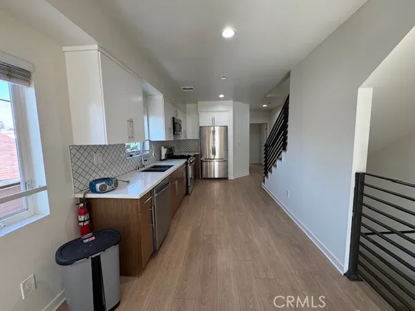 a kitchen with a refrigerator and a sink