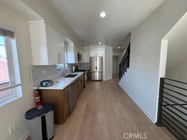 a kitchen with a refrigerator and a sink