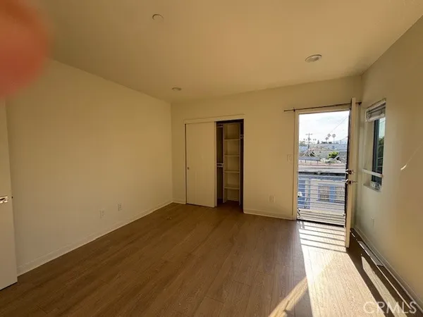 a view of wooden floor and windows in a room