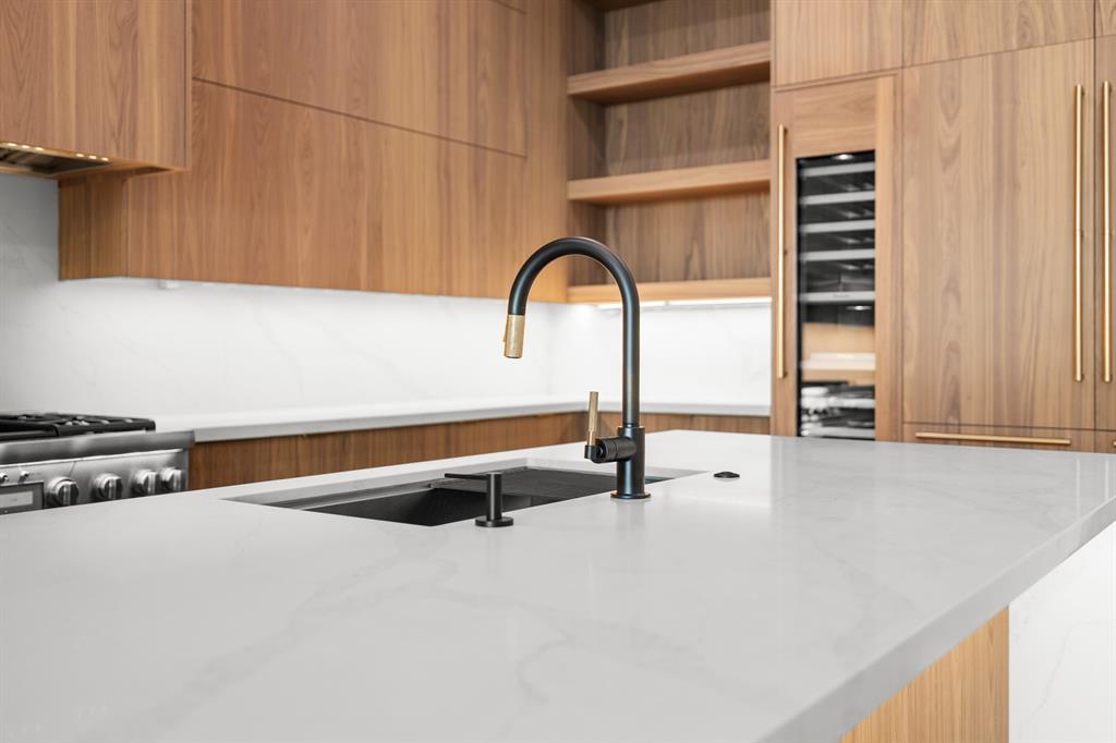 6231 McCommas Boulevard Dallas, TX 75214 - Photo 13 of 40 a close view of a faucet a sink and a stove in the kitchen