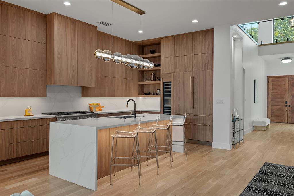 6231 McCommas Boulevard Dallas, TX 75214 - Photo 15 of 40 a kitchen with stainless steel appliances granite countertop a sink and a refrigerator