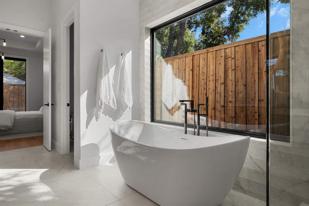 6231 McCommas Boulevard Dallas, TX 75214 - Photo 25 of 40 a living room with large glass windows and furniture