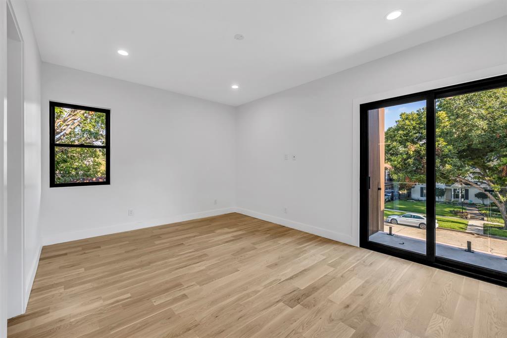 6231 McCommas Boulevard Dallas, TX 75214 - Photo 28 of 40 a view of an empty room with wooden floor and a window