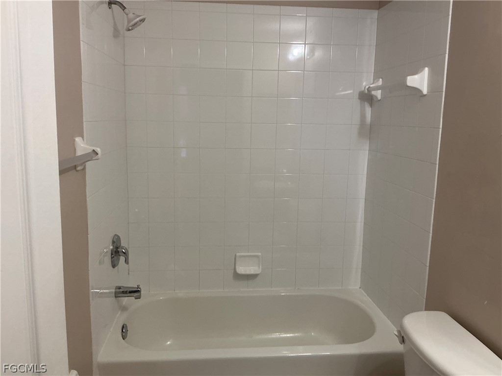 8554 Athena Court Lehigh Acres, FL 33971 - Photo 11 of 22 a bathroom with a tub