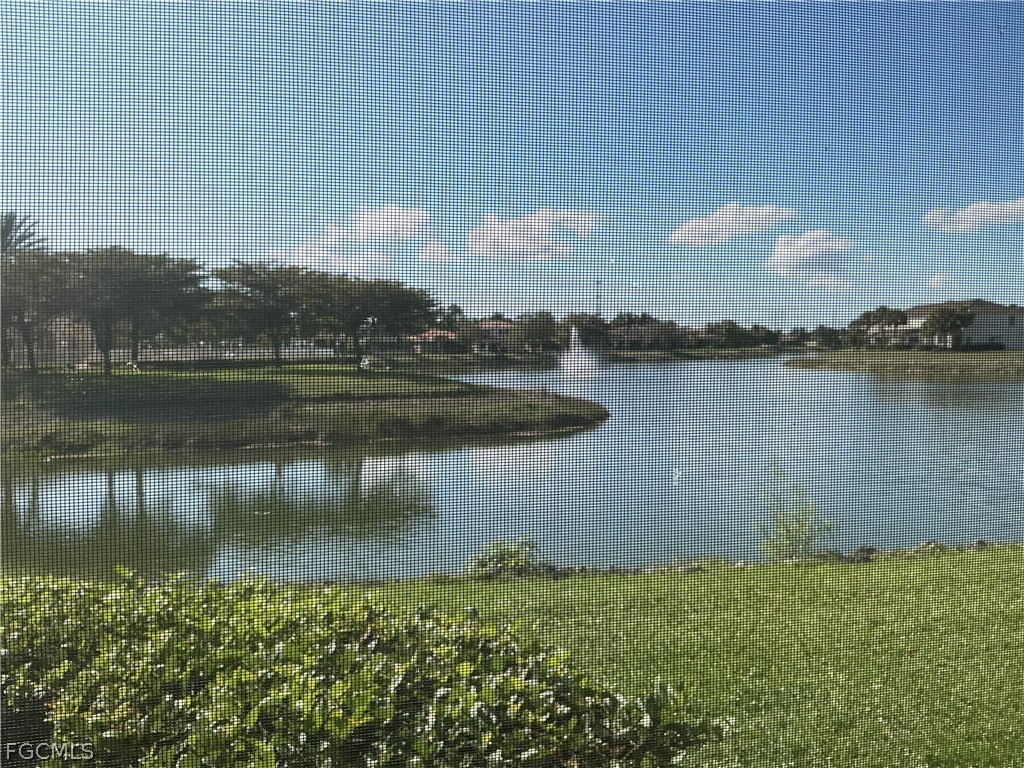 8554 Athena Court Lehigh Acres, FL 33971 - Photo 12 of 22 a view of a lake with houses in the back