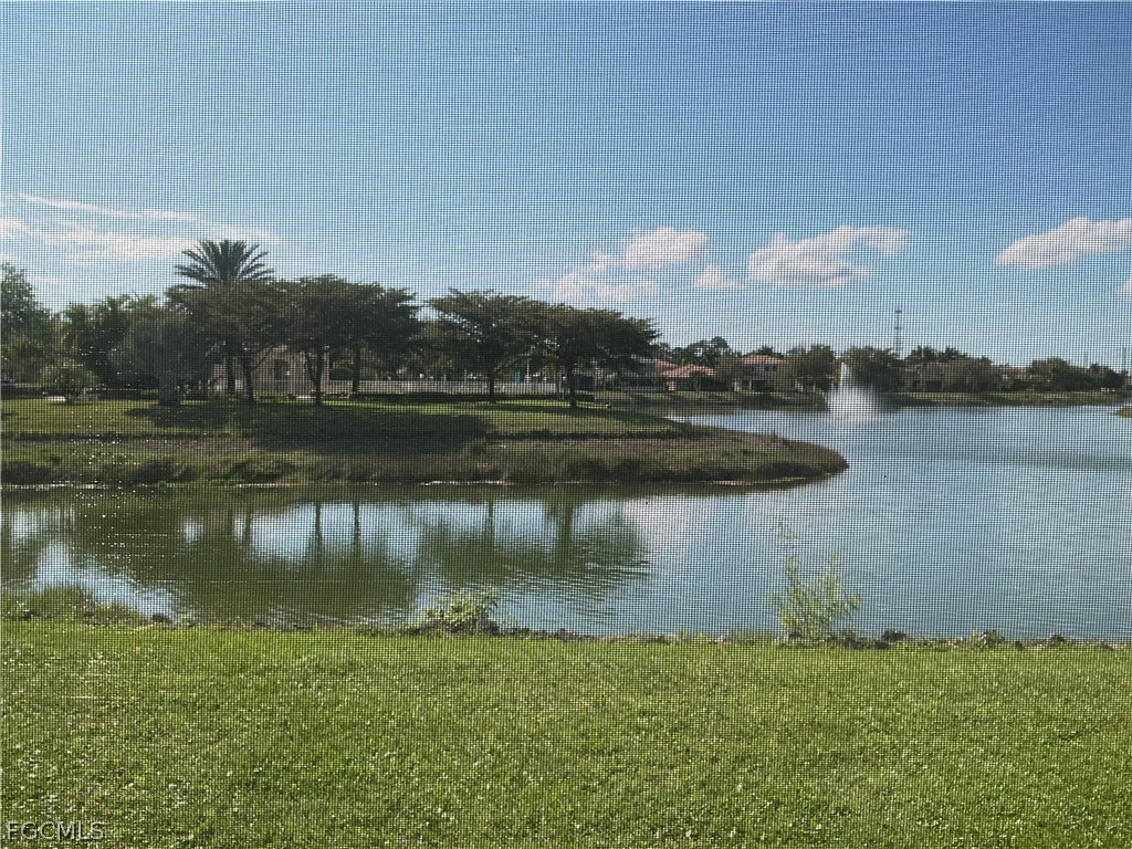 8554 Athena Court Lehigh Acres, FL 33971 - Photo 13 of 22 a view of a lake with houses in the back