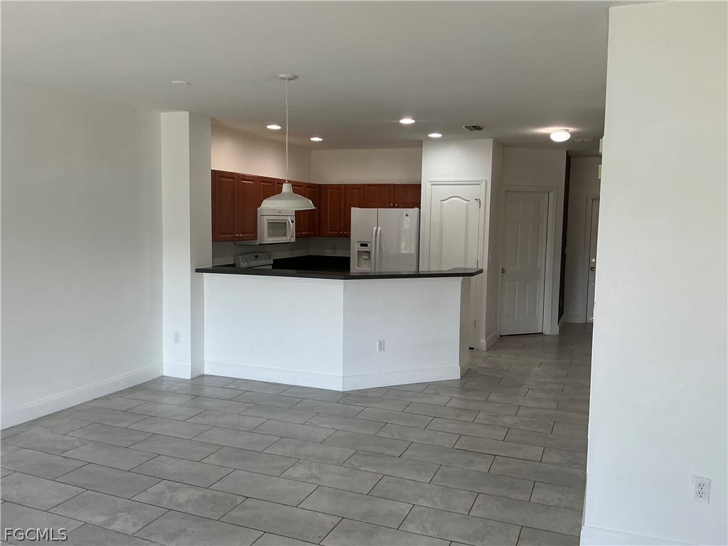 8554 Athena Court Lehigh Acres, FL 33971 - Photo 3 of 22 a view of a kitchen with a sink and cabinets