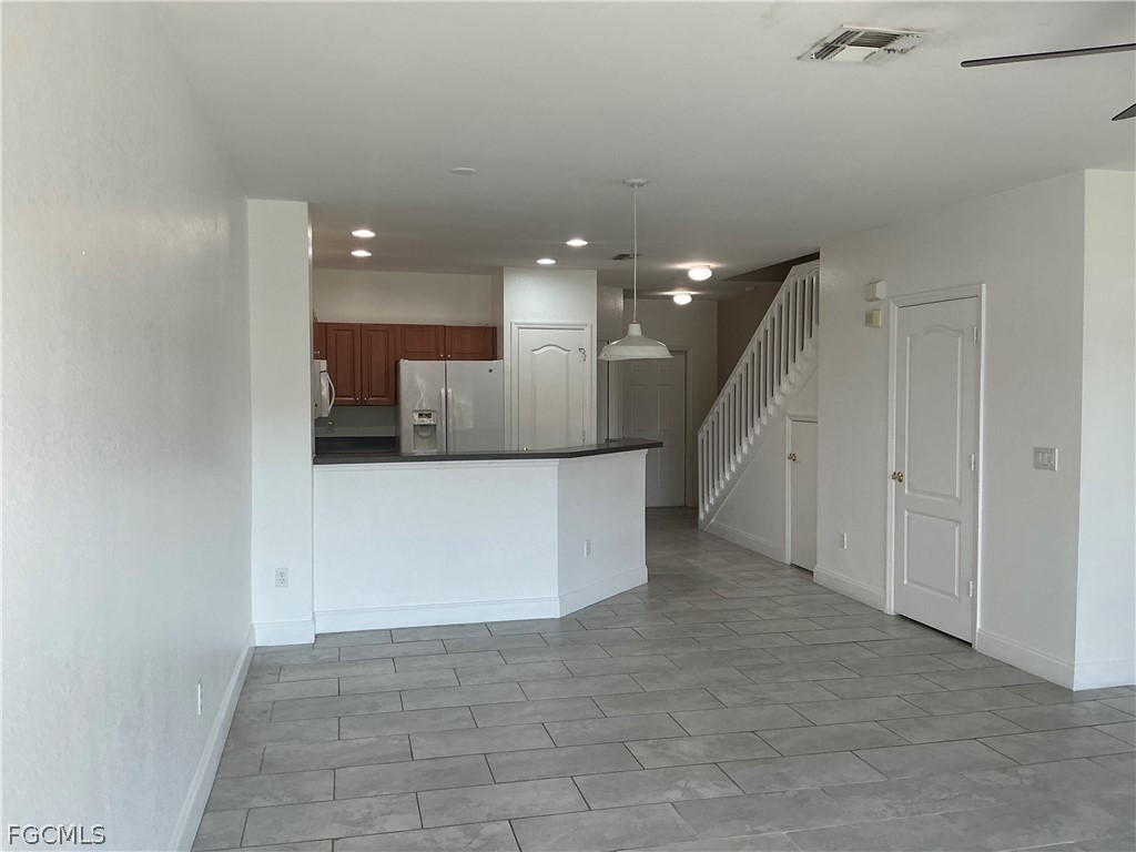 8554 Athena Court Lehigh Acres, FL 33971 - Photo 4 of 22 a view of a kitchen with a refrigerator and a window