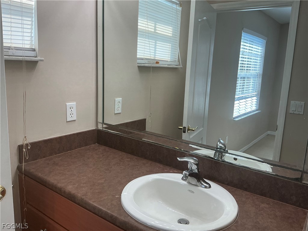 8554 Athena Court Lehigh Acres, FL 33971 - Photo 7 of 22 a bathroom with a sink and a mirror