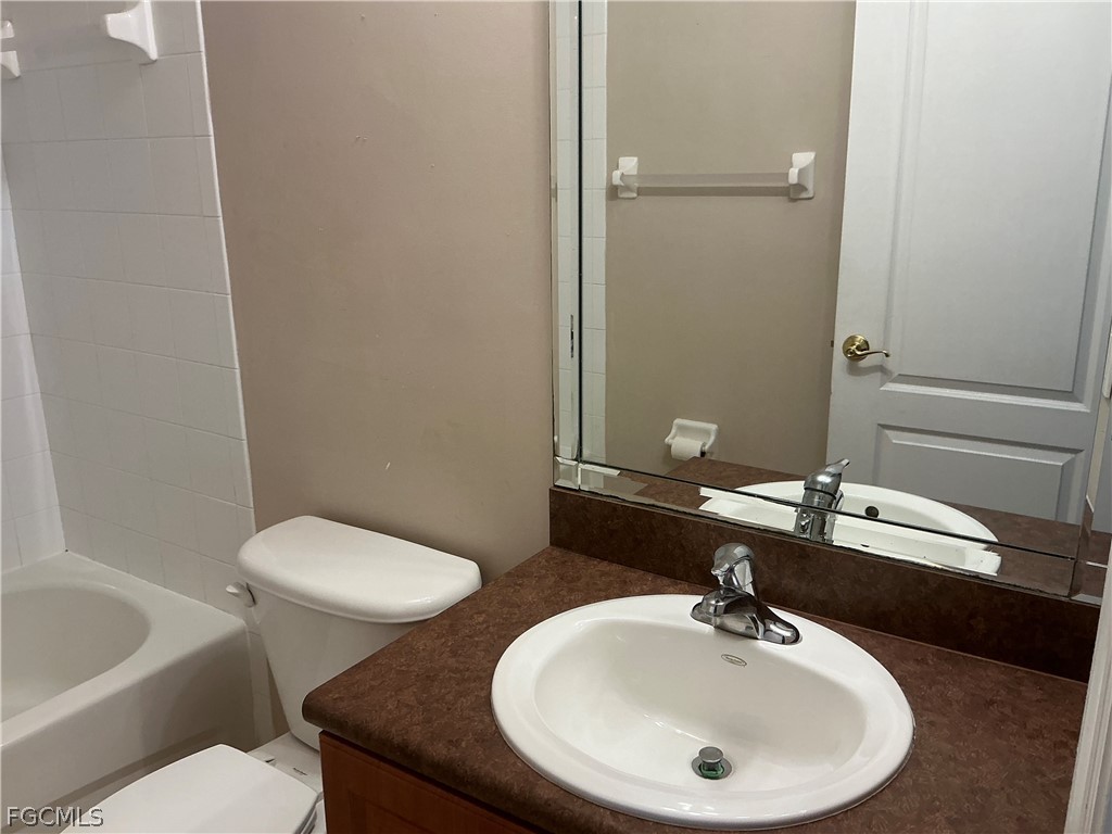 8554 Athena Court Lehigh Acres, FL 33971 - Photo 10 of 22 a bathroom with a sink and a mirror