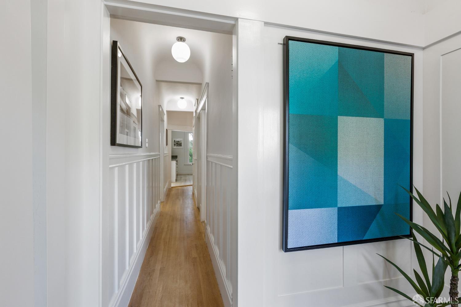 931 Clayton Street San Francisco, CA 94117 - Photo 15 of 28 a view of a hallway with wooden floor and a living room