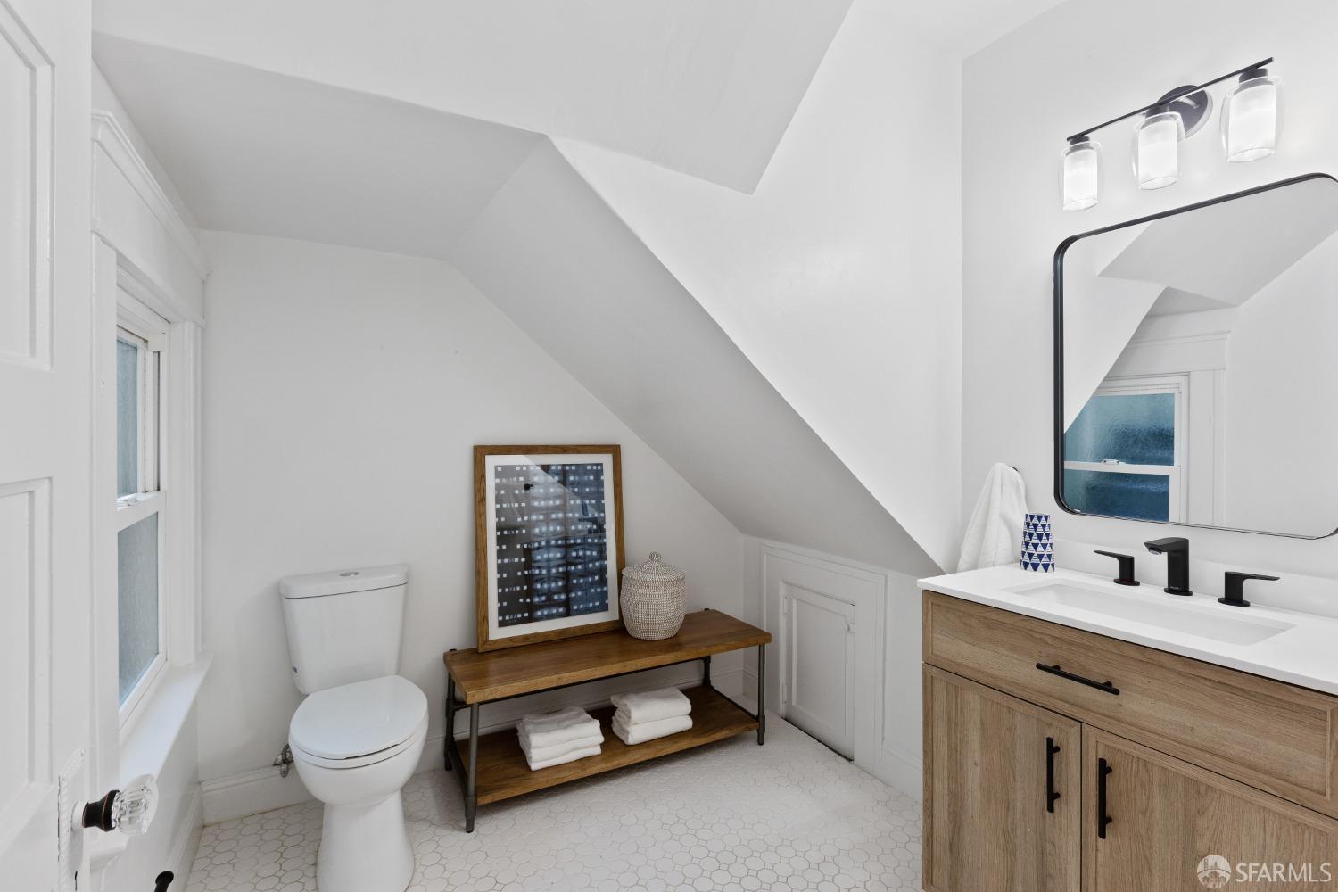 931 Clayton Street San Francisco, CA 94117 - Photo 18 of 28 a bathroom with a toilet sink and mirror