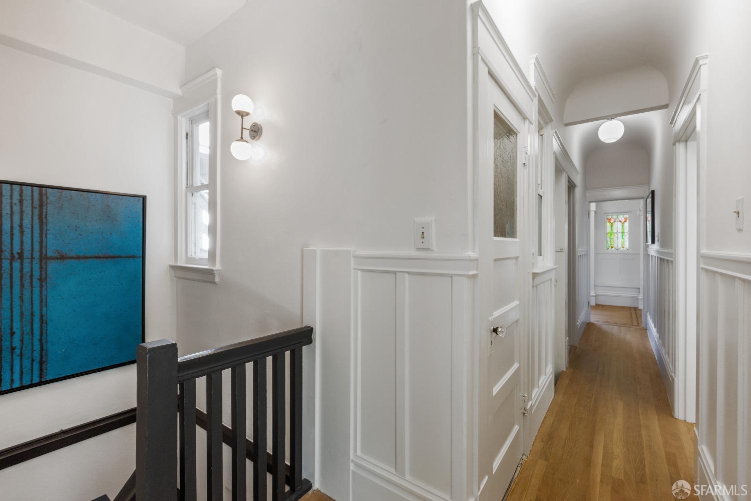931 Clayton Street San Francisco, CA 94117 - Photo 19 of 28 a view of a hallway with wooden floor and staircase