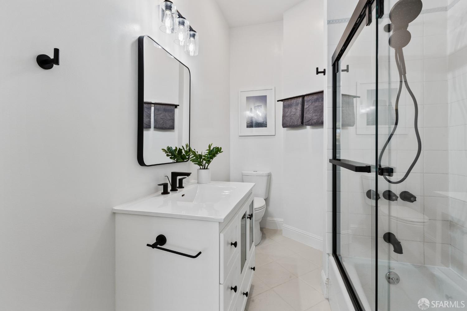 931 Clayton Street San Francisco, CA 94117 - Photo 22 of 28 a bathroom with a sink vanity and mirror