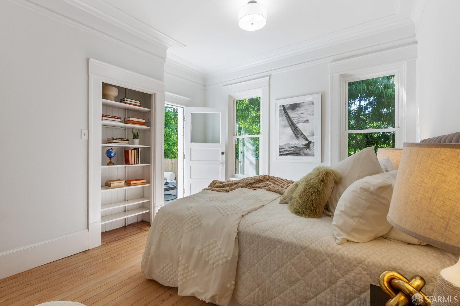 931 Clayton Street San Francisco, CA 94117 - Photo 23 of 28 a bedroom with a large bed and a book shelf