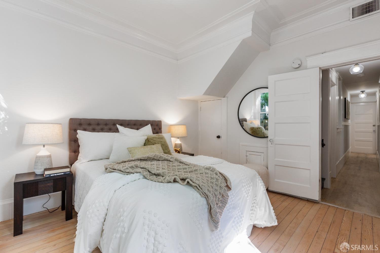 931 Clayton Street San Francisco, CA 94117 - Photo 24 of 28 a bedroom with a bed and a mirror
