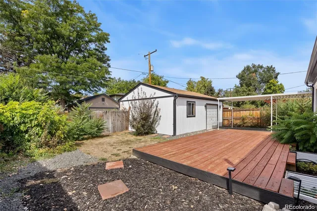a view of house with big yard and potted plants