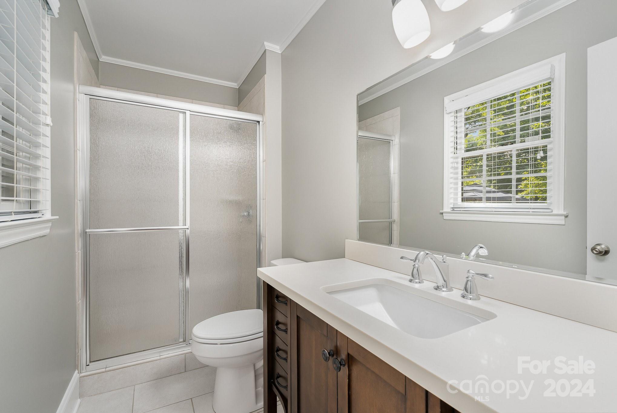 6529 Idlebrook Drive Charlotte, NC 28212 - Photo 13 of 28 a bathroom with a sink toilet and shower